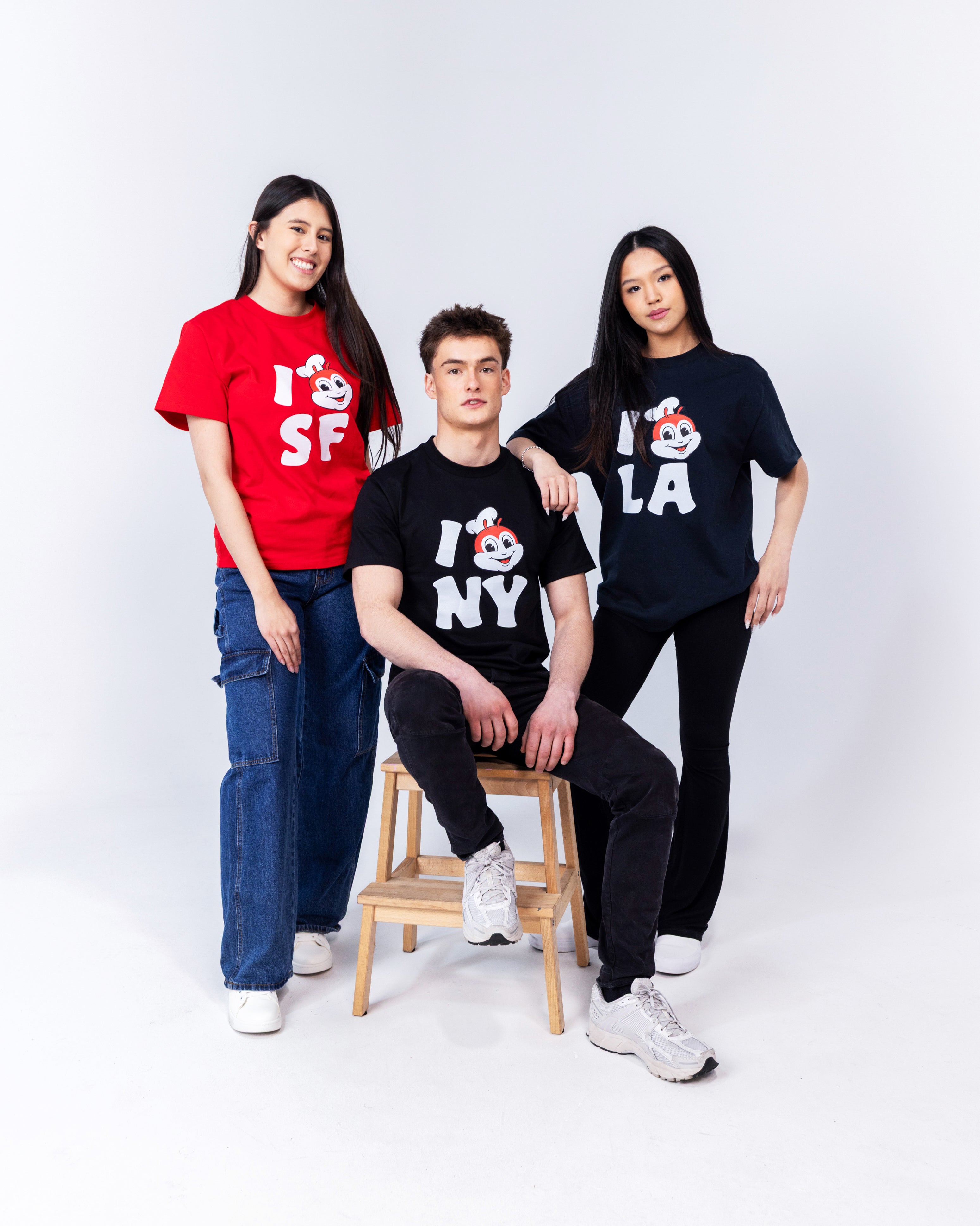 a guy and two girls wearing Jollibee merch t-shirts