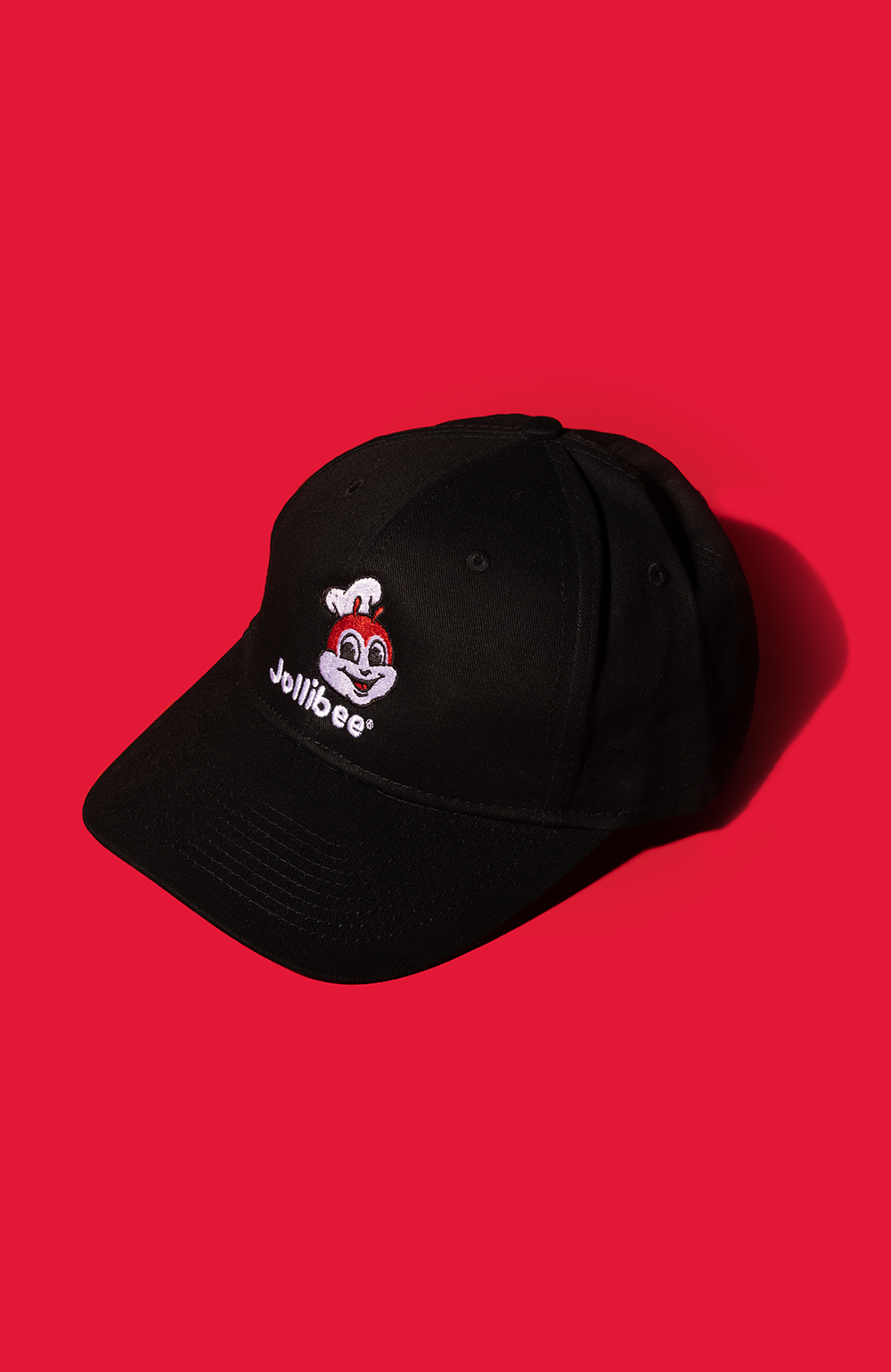 Jollibee black baseball cap on red background