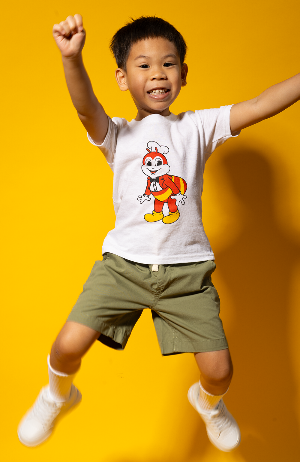 jumping boy wearing the kid mascot white shirt