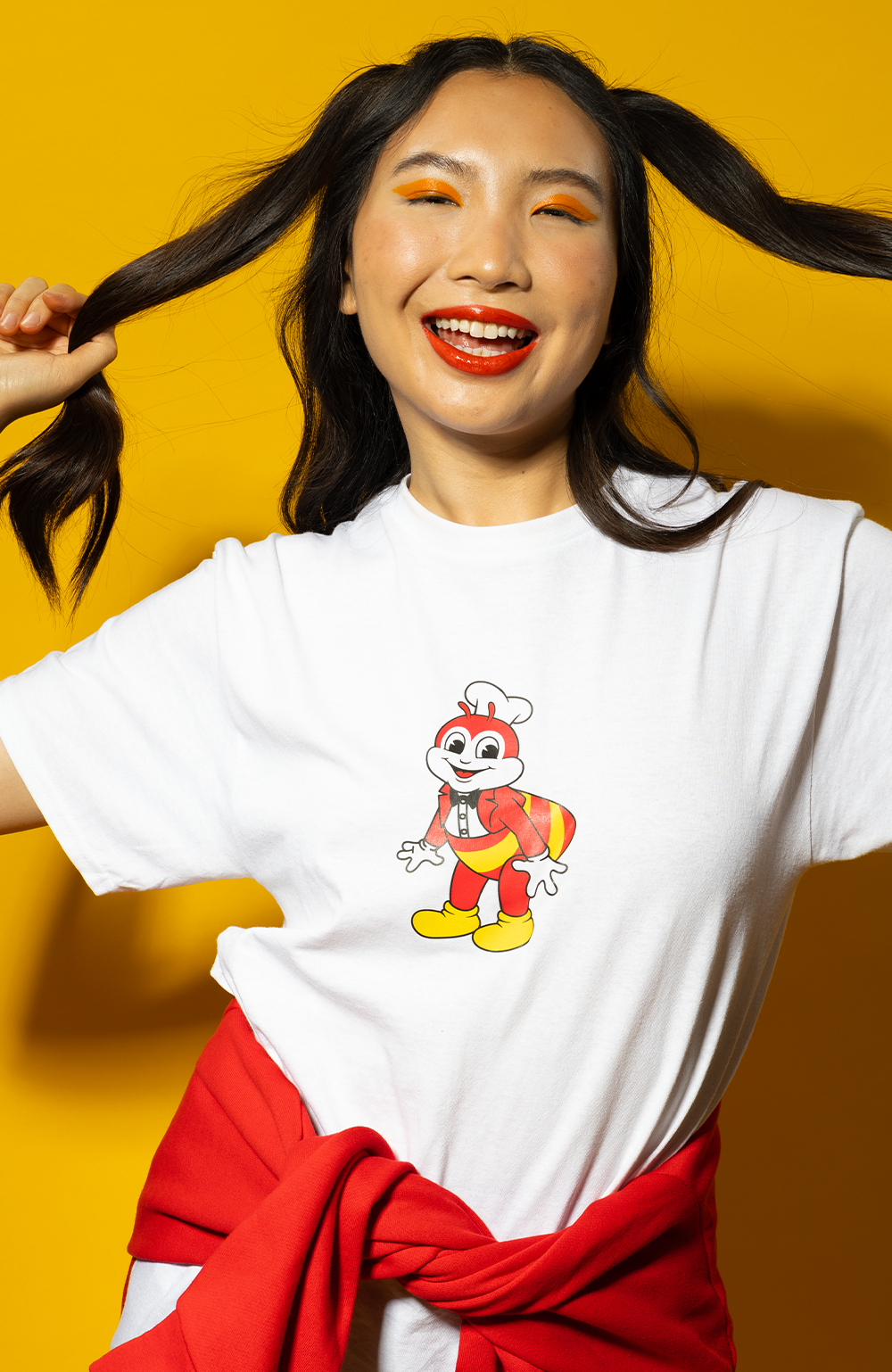 a smiling girl wearing the adult mascot white shirt