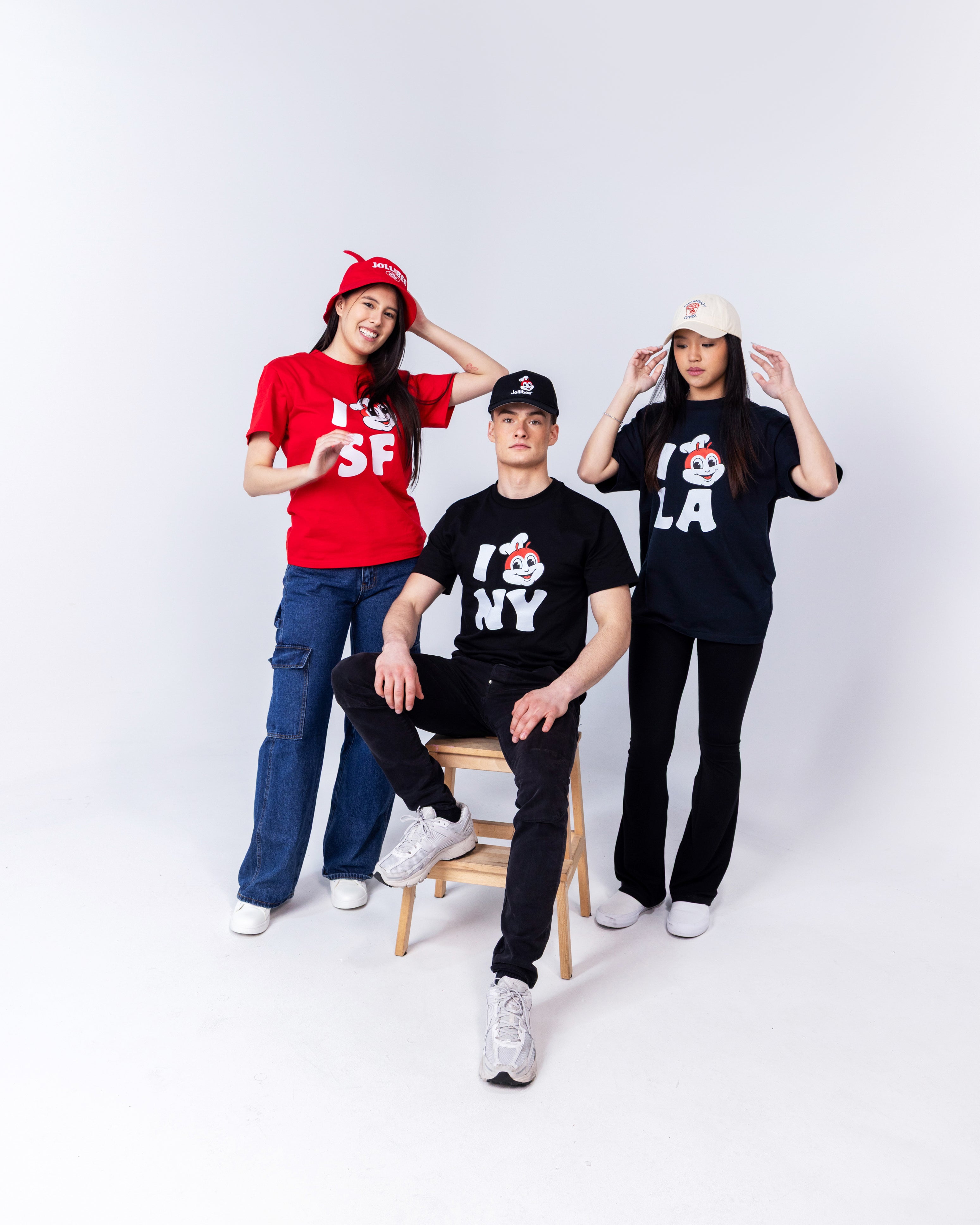 two girls and one boy standing and wearing Jollibee merch