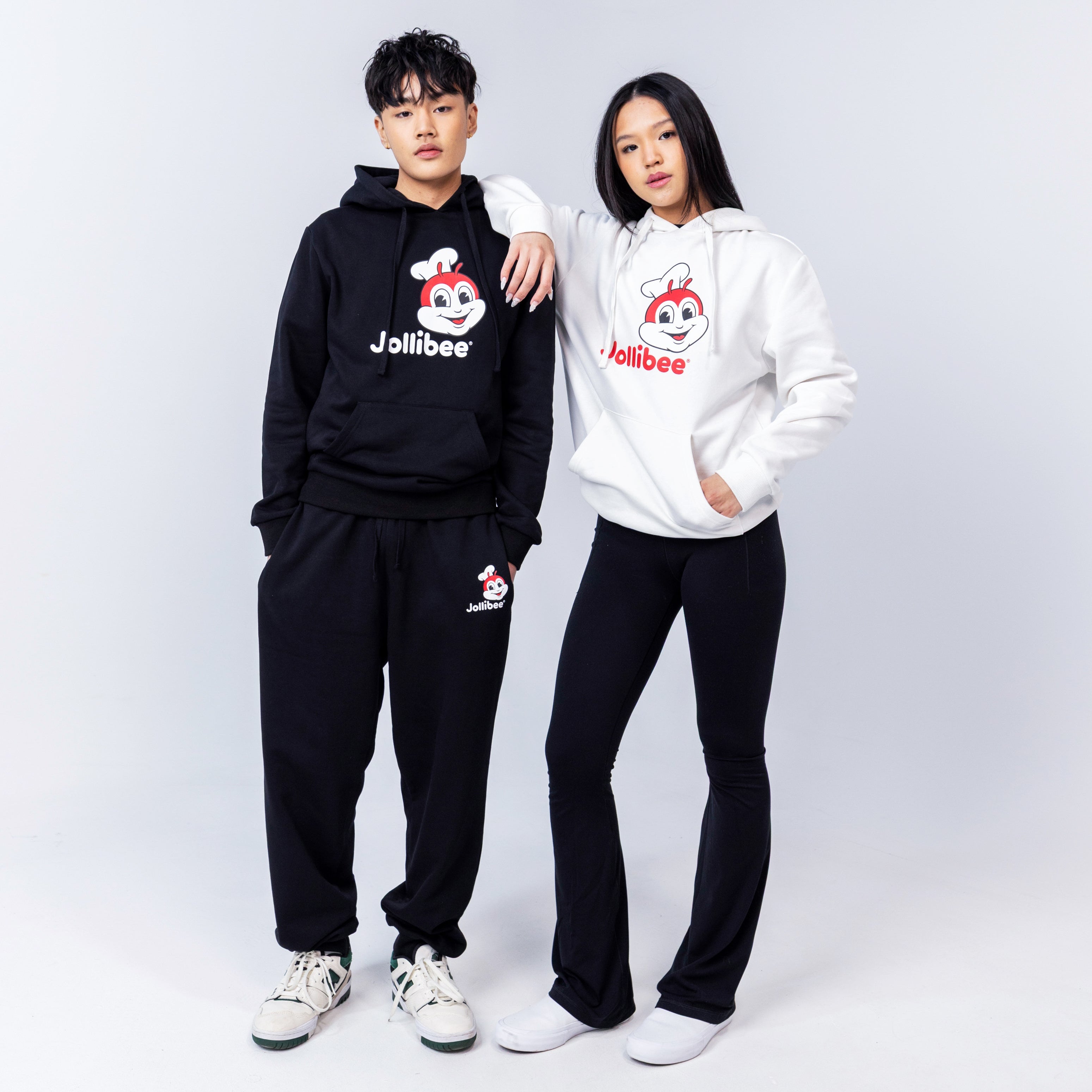 a guy wearing the Jollibee black classic hoodie and girl wearing the white classic hoodie