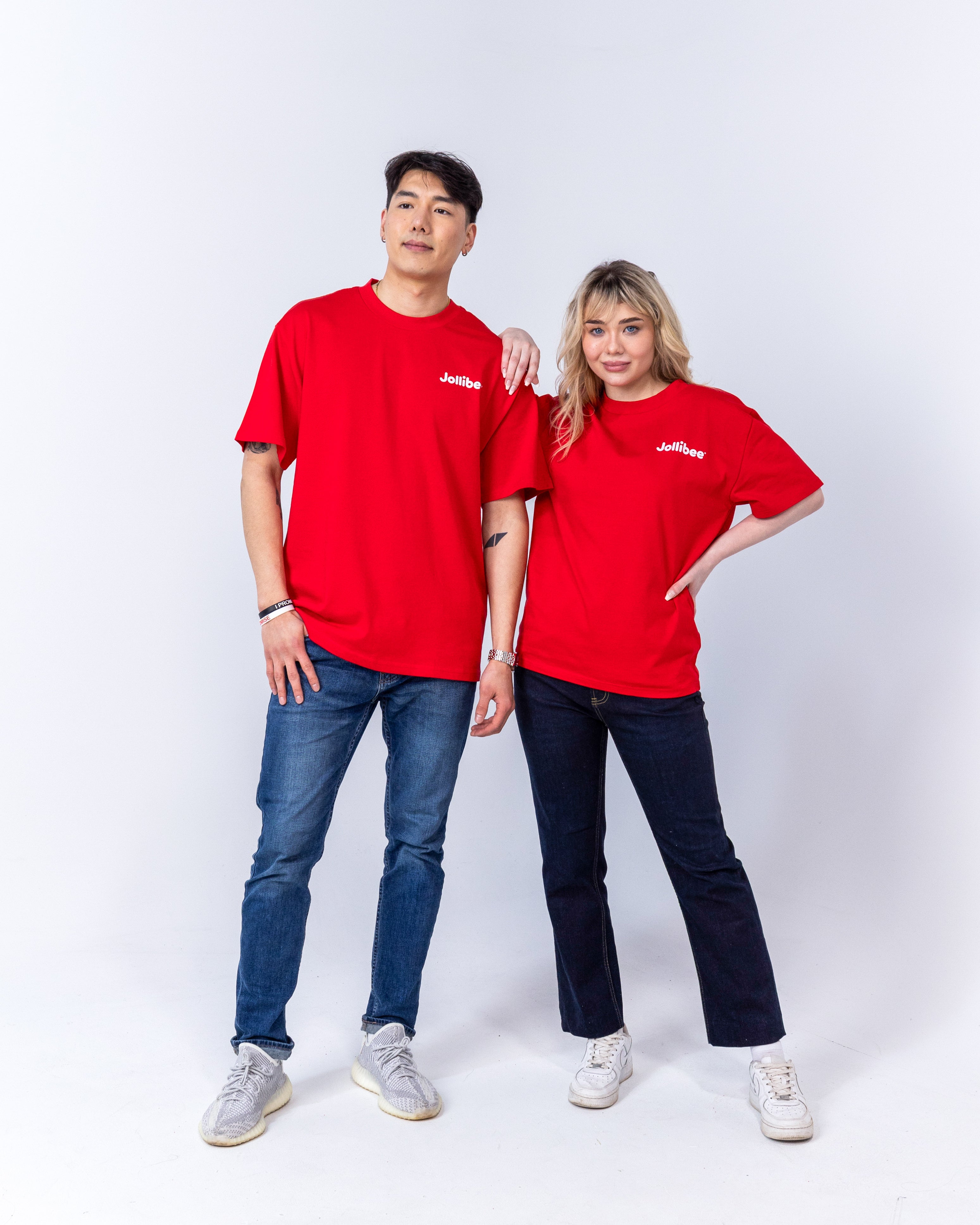 guy and a girl wearing Jollibee merch retro red t-shirts