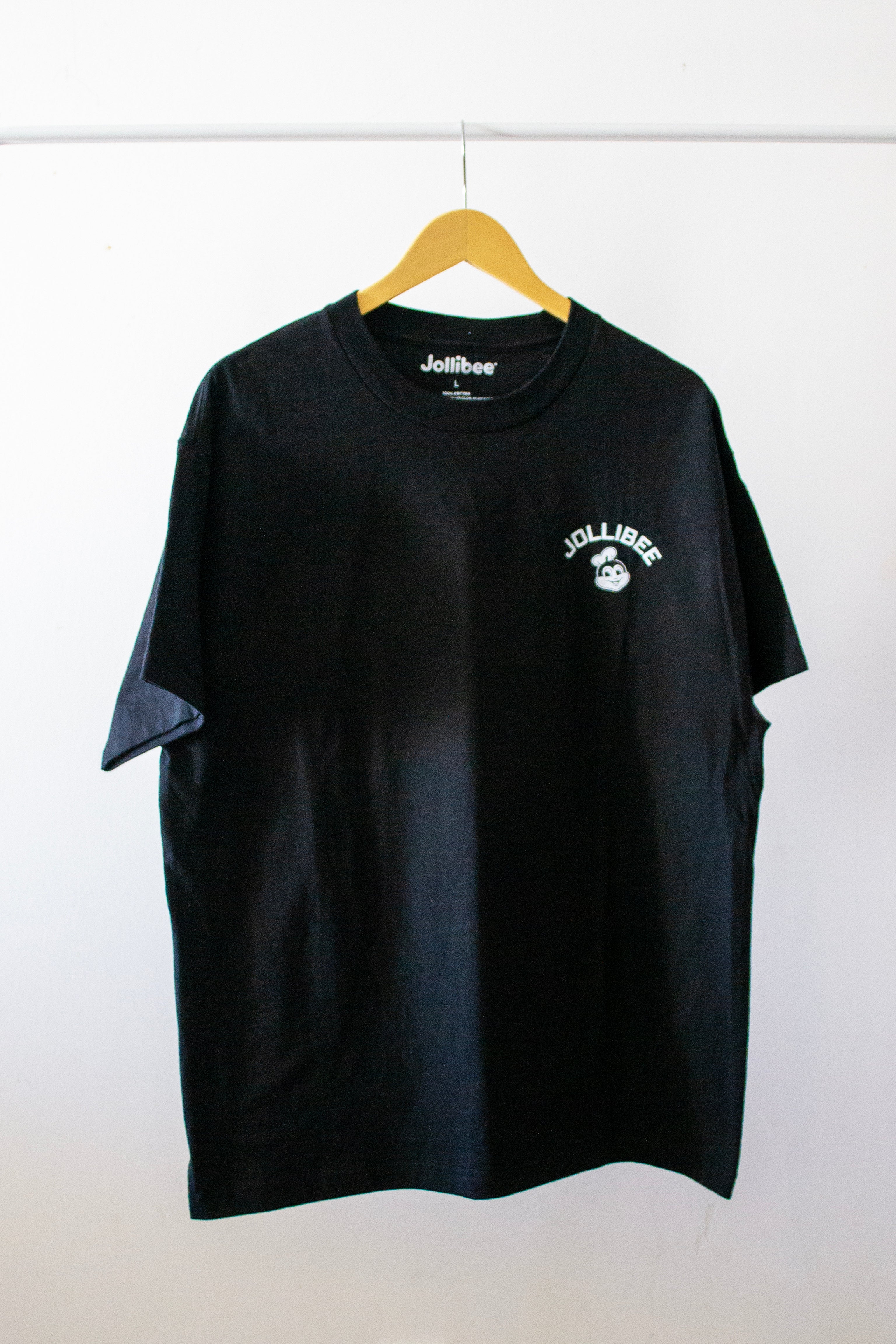 Jollibee merch black shirt on a hanger