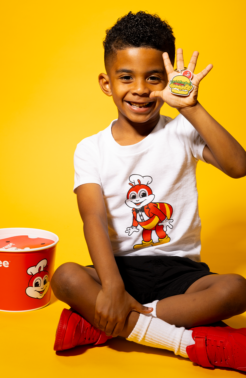 boy wearing the Kid Mascot White Shirt and holding a keychain